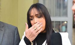 Lisa Gomes cries when she arrives at the police station