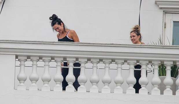 Dua Lipa practices yoga on the balcony of her hotel