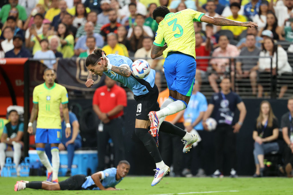 Players from Brazil and Uruguay fight for the ball 