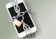 Image shows an iPhone wrapped with a chain closed with a padlock