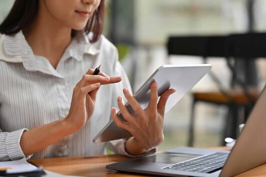 Business woman in front of tablet and notebook